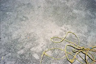 Concrete surface with a yellow rope.